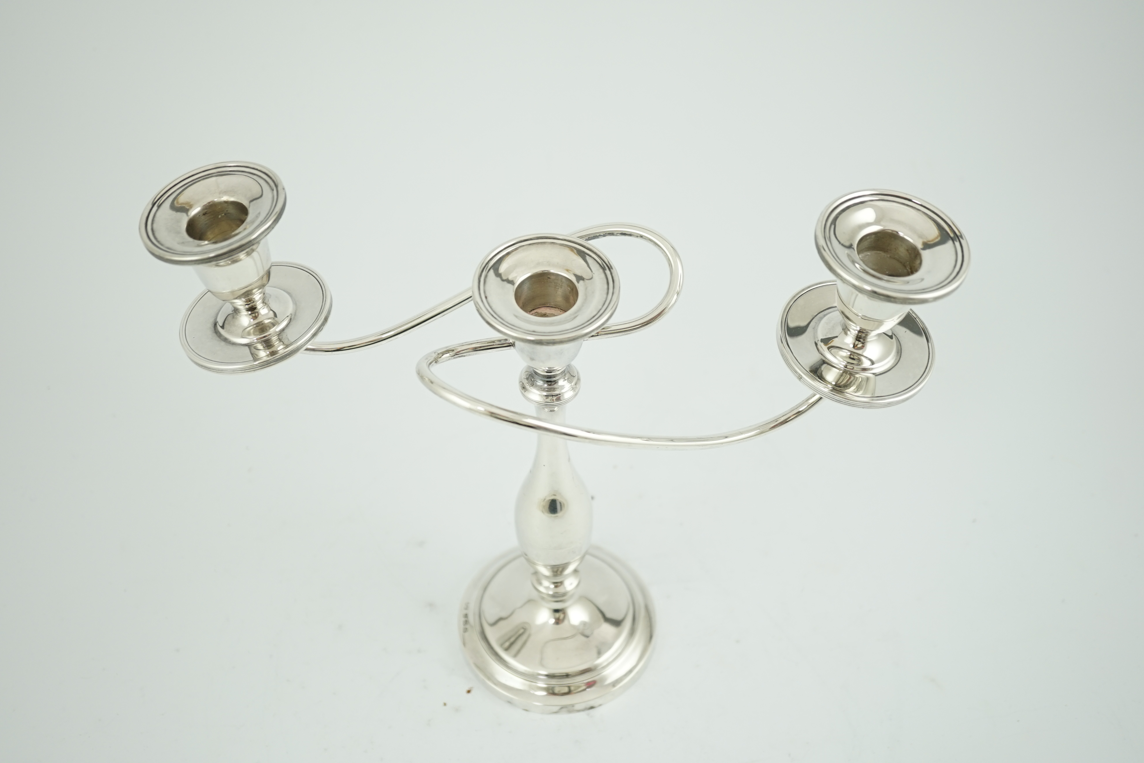 A George VI silver two branch, three light candelabrum, by William Adams Ltd